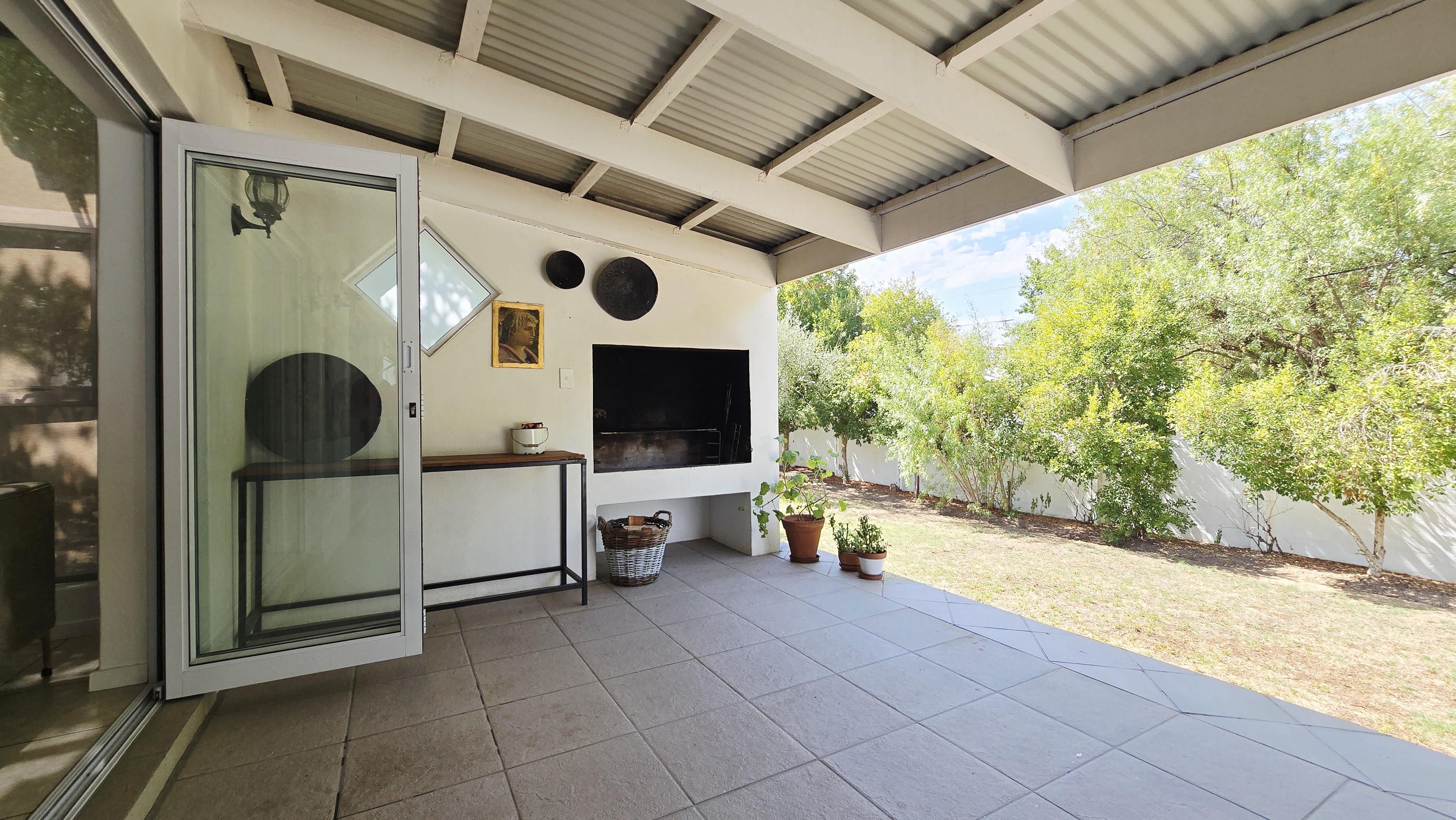 This Is Not The Post Office covered garden terrace with built-in braai